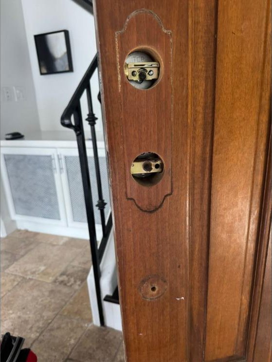 Locksmith installing a deadbolt lock in a Westside home